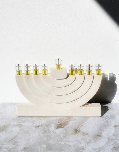 Handcrafted stone-look luxury menorah with layered arch design and glass oil cups, created for a modern elegant Hanukkah home